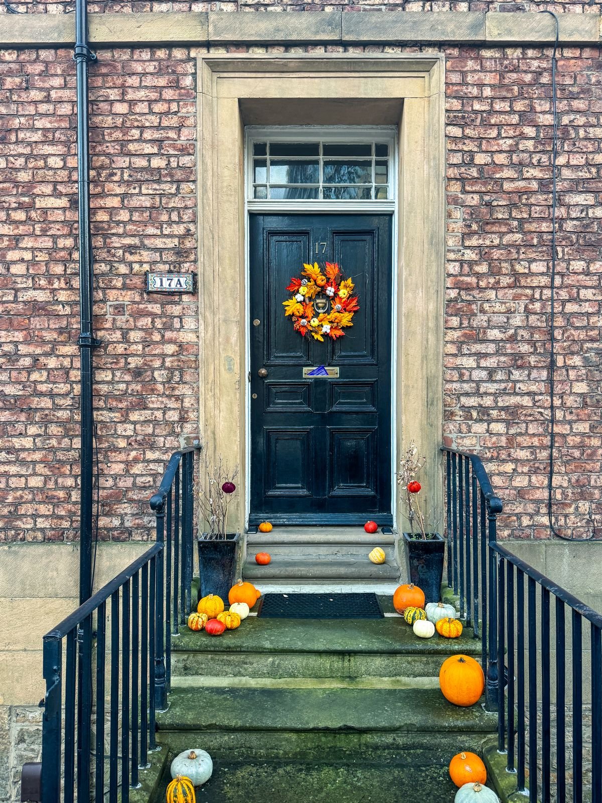 Childrens halloween drawings framed and hung in a hallway gallery wall
