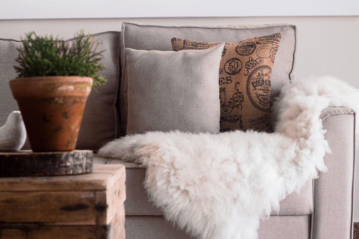 Pastel candy corn shaped cushions on a sofa for sweet halloween home decor ideas