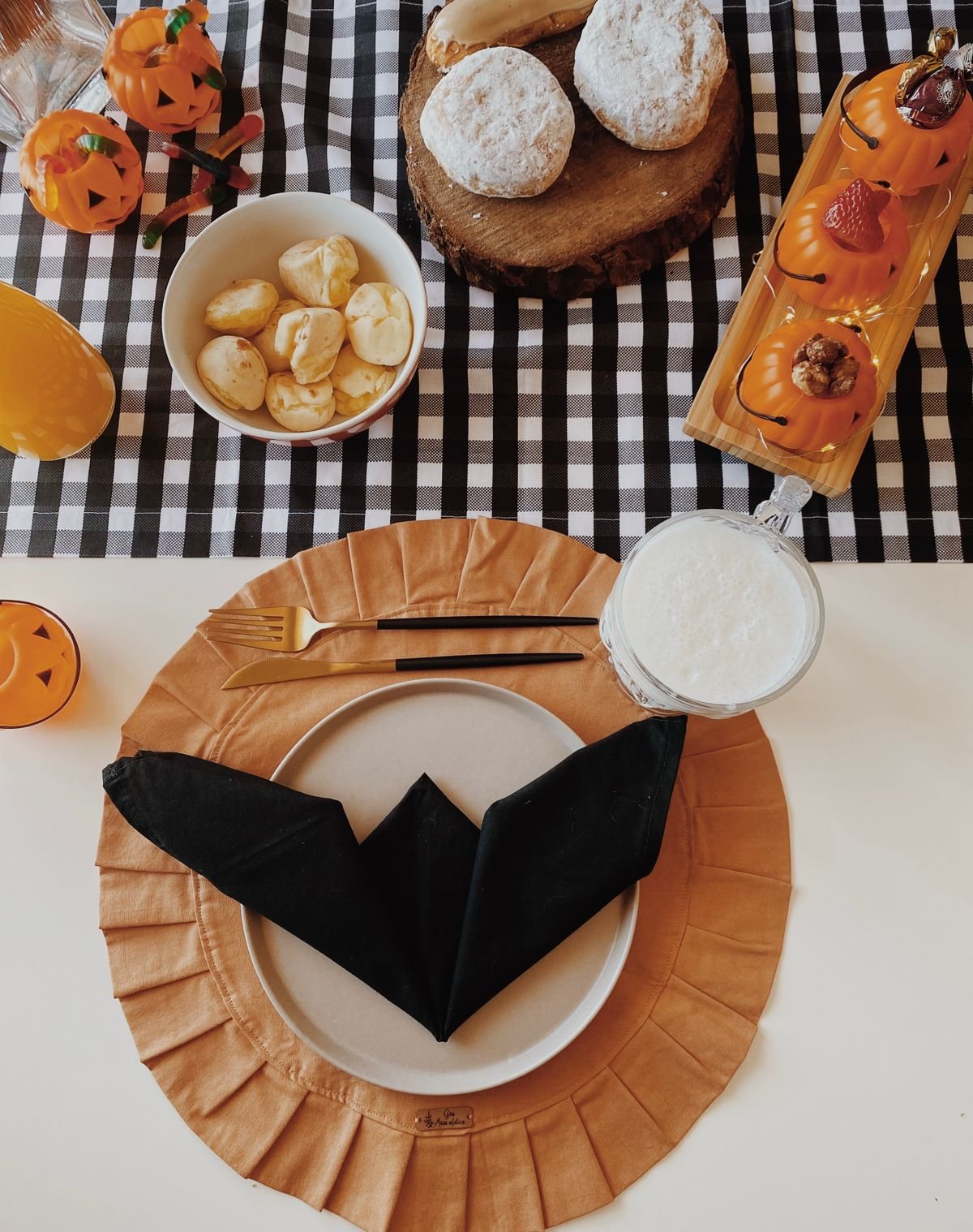 breakfast nook table with bowl of mini pumpkins and halloween accents