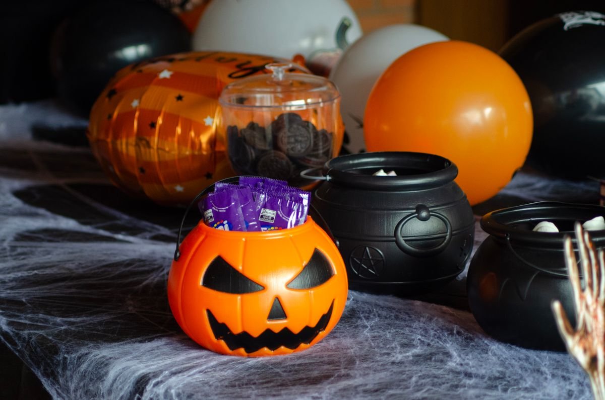 halloween candy cauldron with sweets on kitchen counter