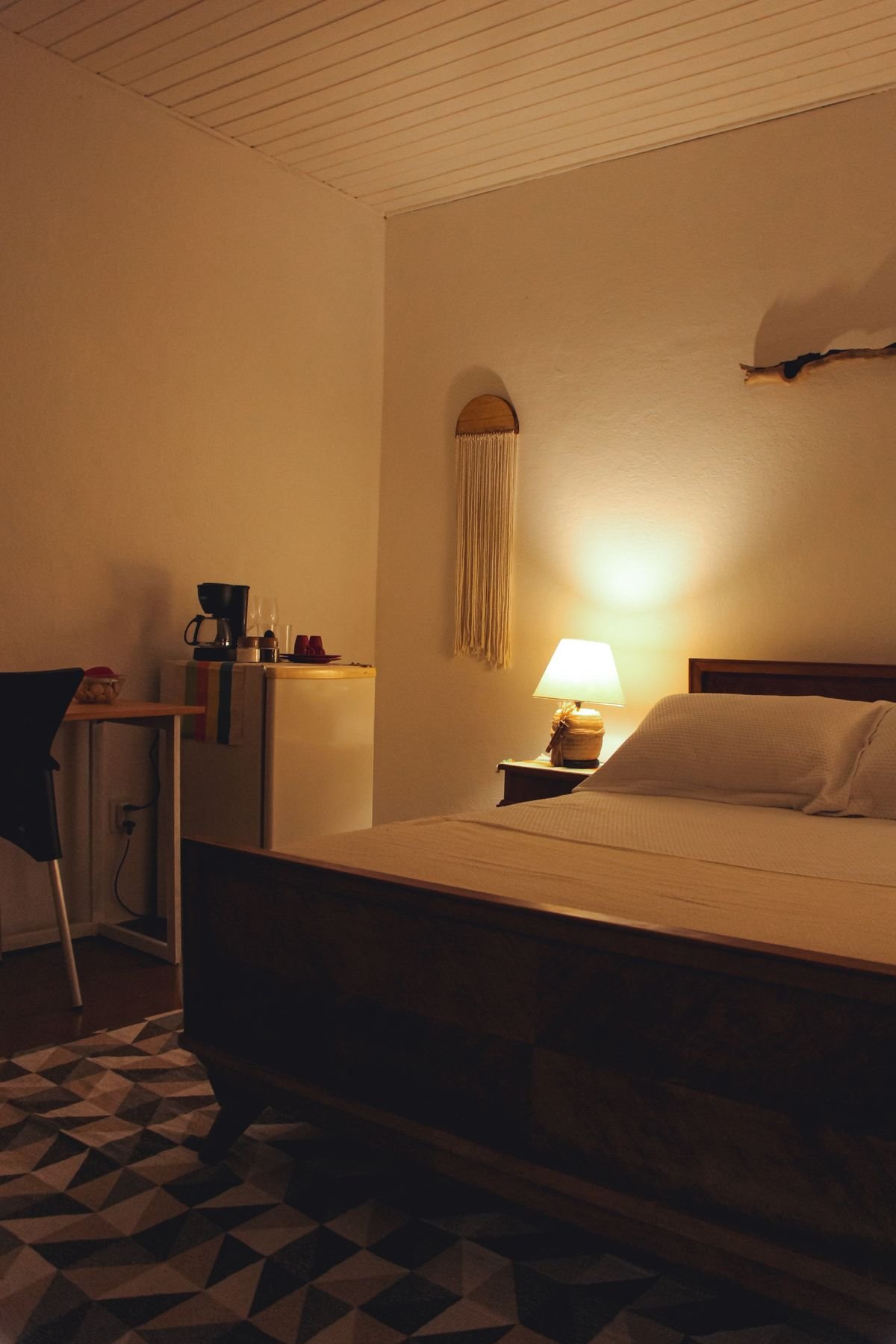 guest bedroom with fall throw and eerie halloween pumpkin lamp