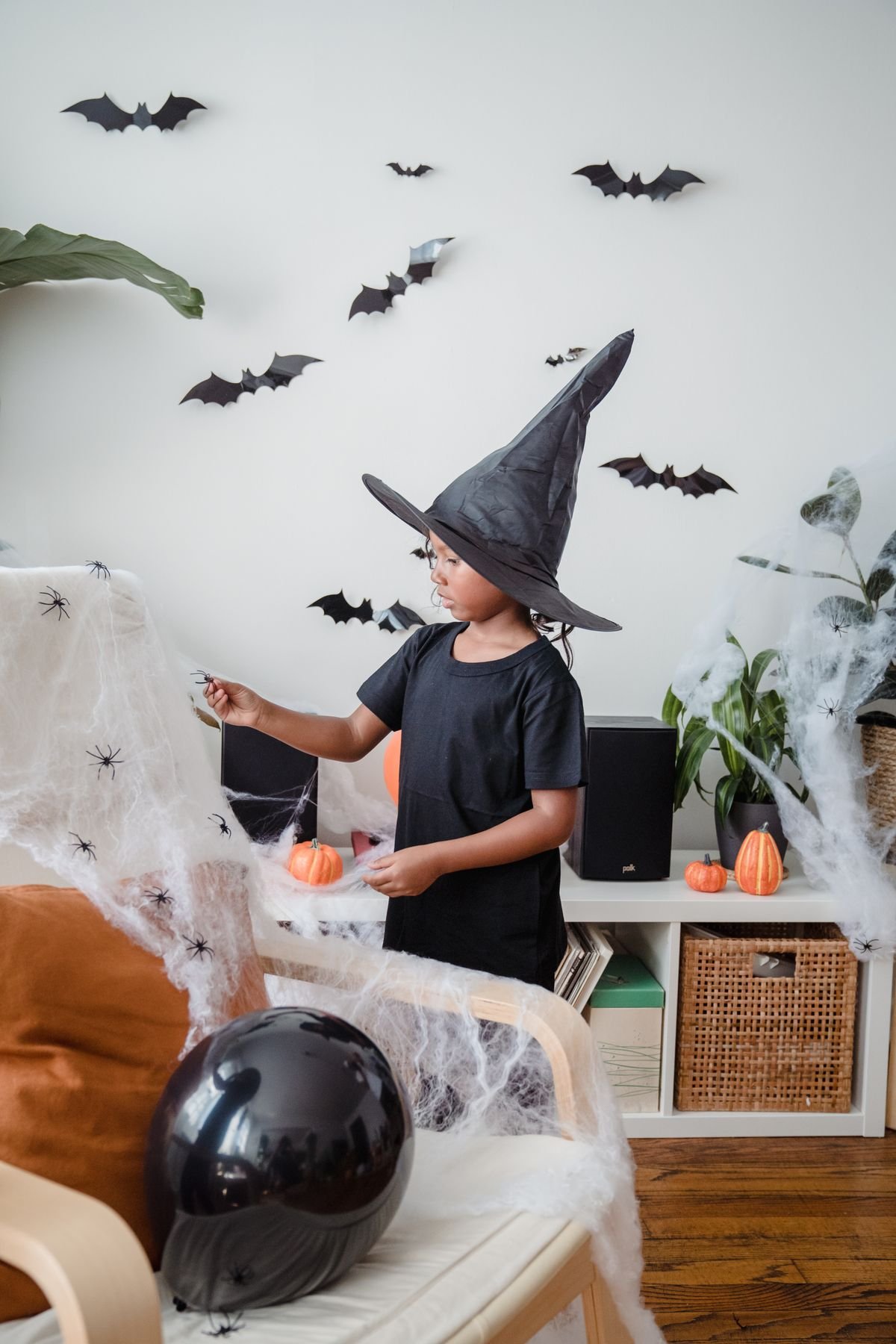kids bedroom with autumn leaf garland and friendly halloween ghosts