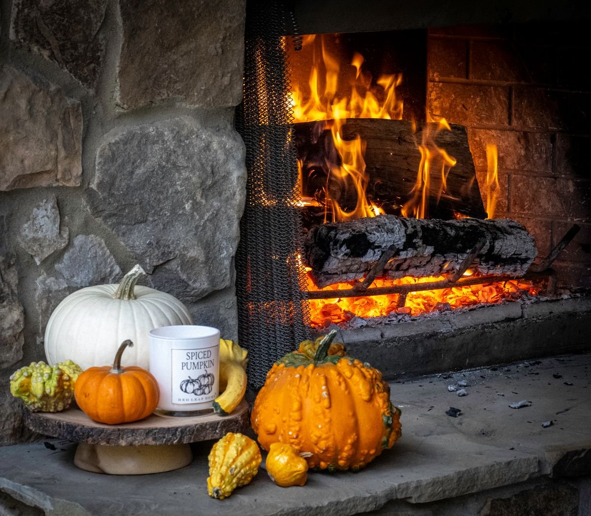 Fireplace mantel dressed with a pumpkin garland for halloween living room decor