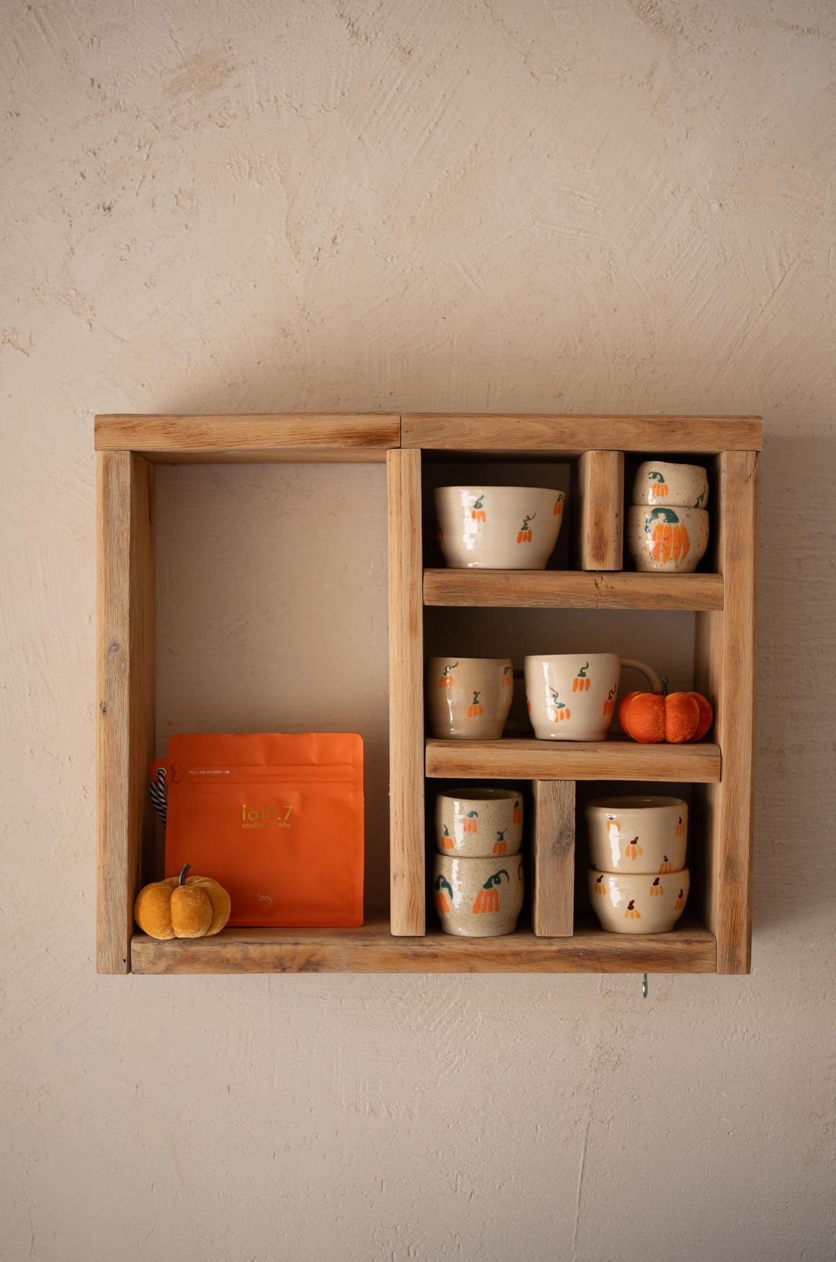 Open kitchen shelves decorated with mini pumpkins for halloween
