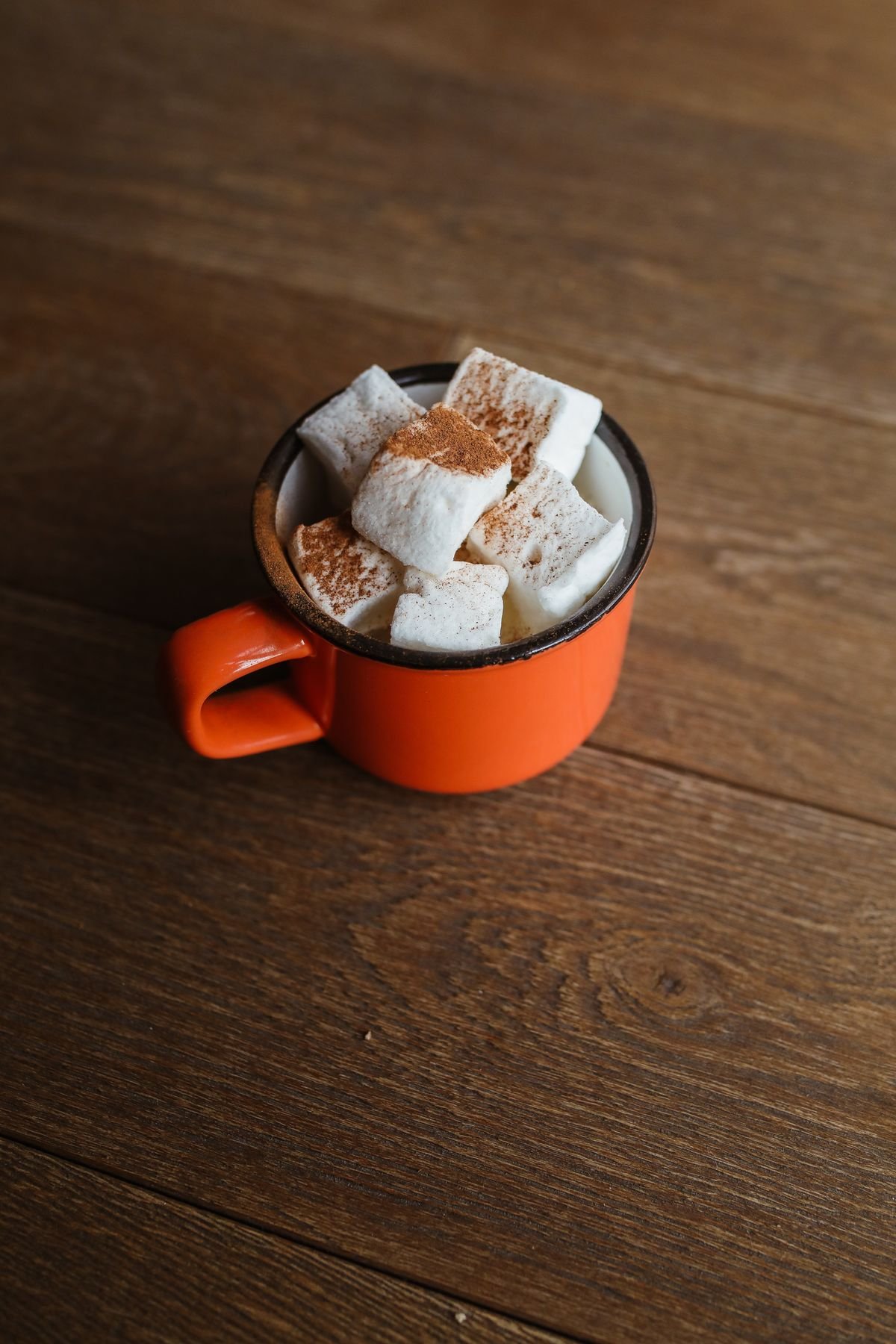 Pumpkin spice drinks station with autumn mugs on a kitchen counter