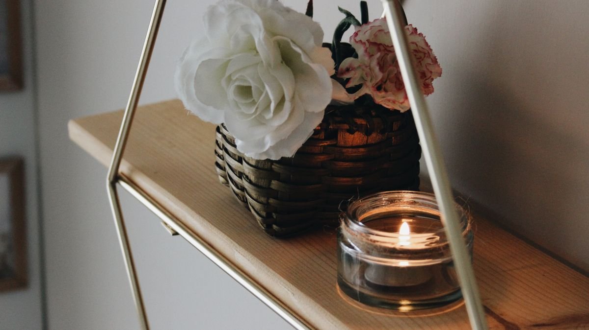 Lit candle on a bathroom shelf with halloween styling