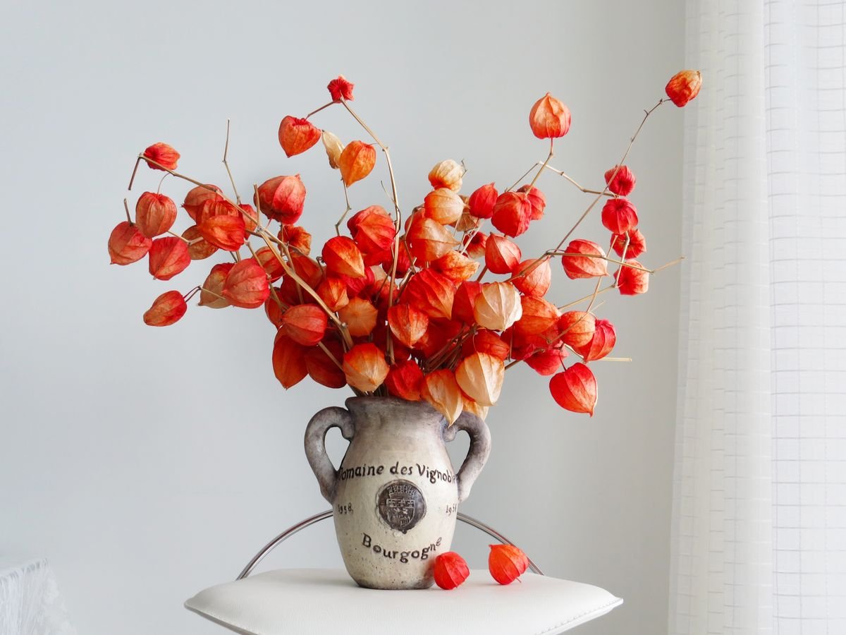 Tall vase with dried autumn stems and pampas grass