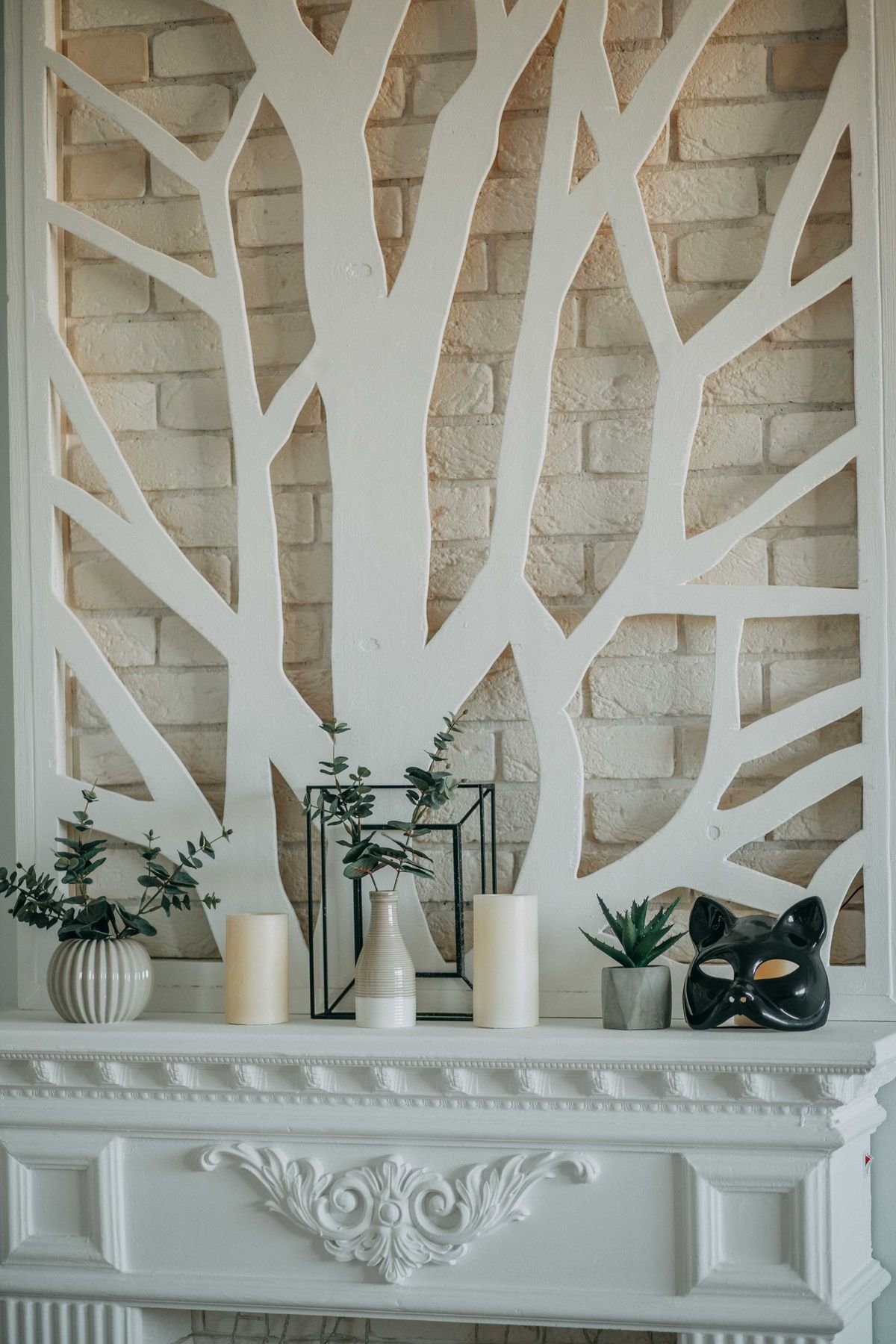 Fireplace mantel lined with a row of pumpkins for halloween