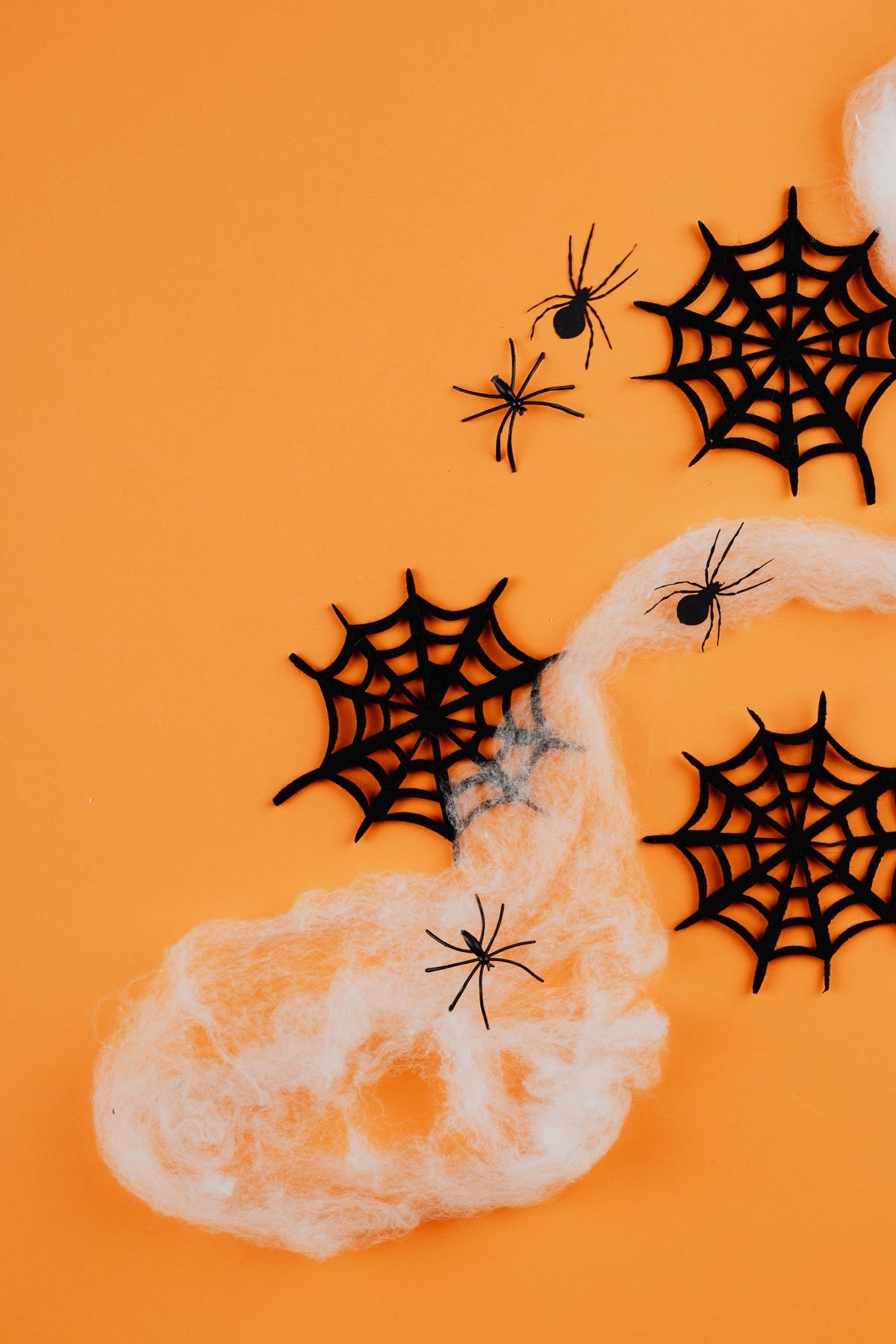 Faux spiderwebs stretched across a porch corner