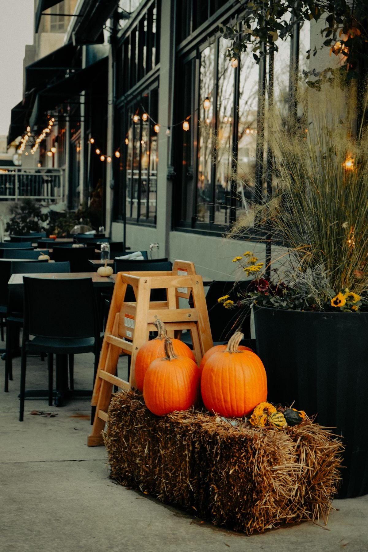 Pumpkins and hay bales at an autumn outdoor cafe setting