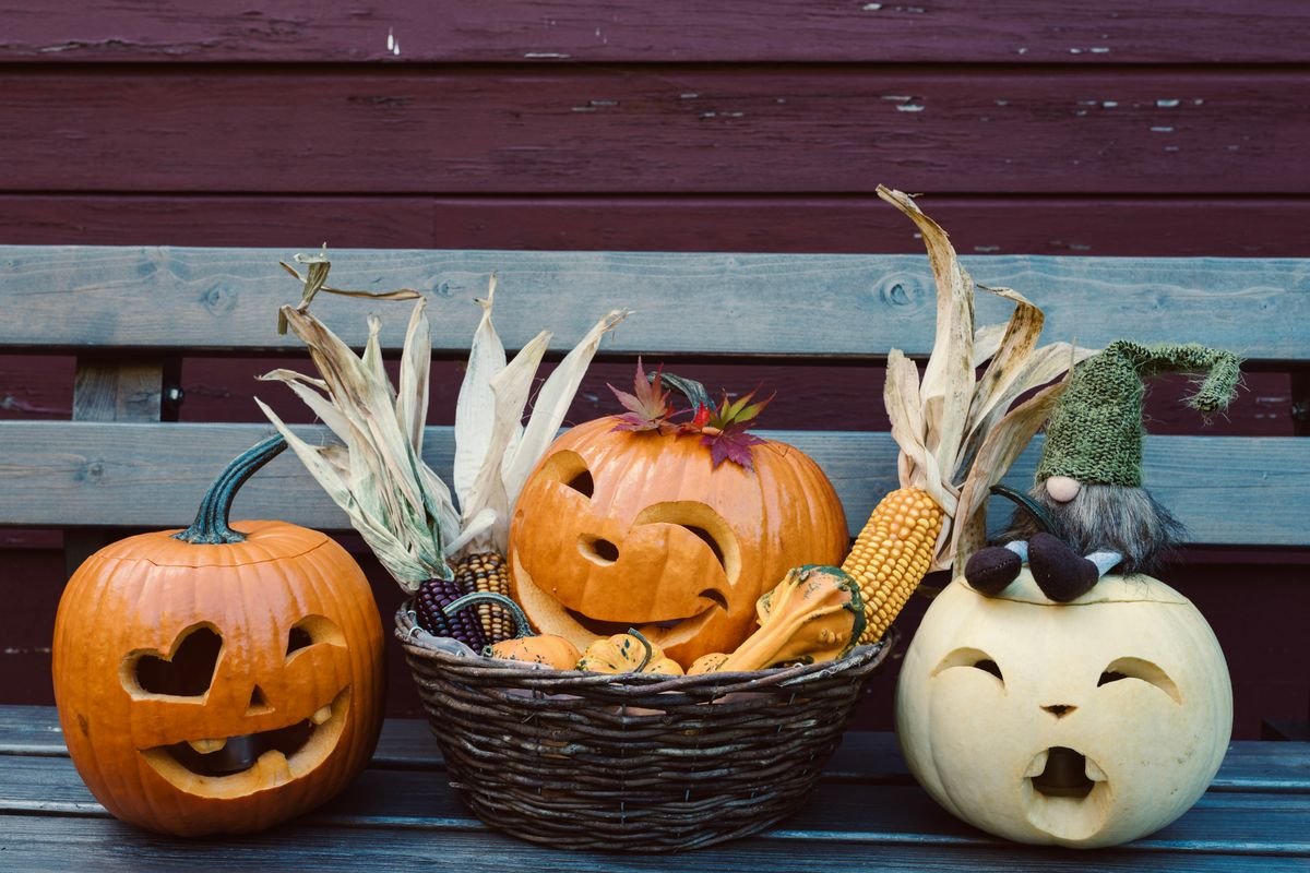 Entryway bench with harvest baskets pumpkins and a smiling pumpkin