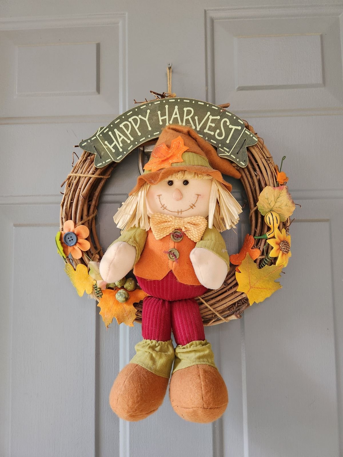 Autumn wreath with black bat clips on a front door for fall halloween decor