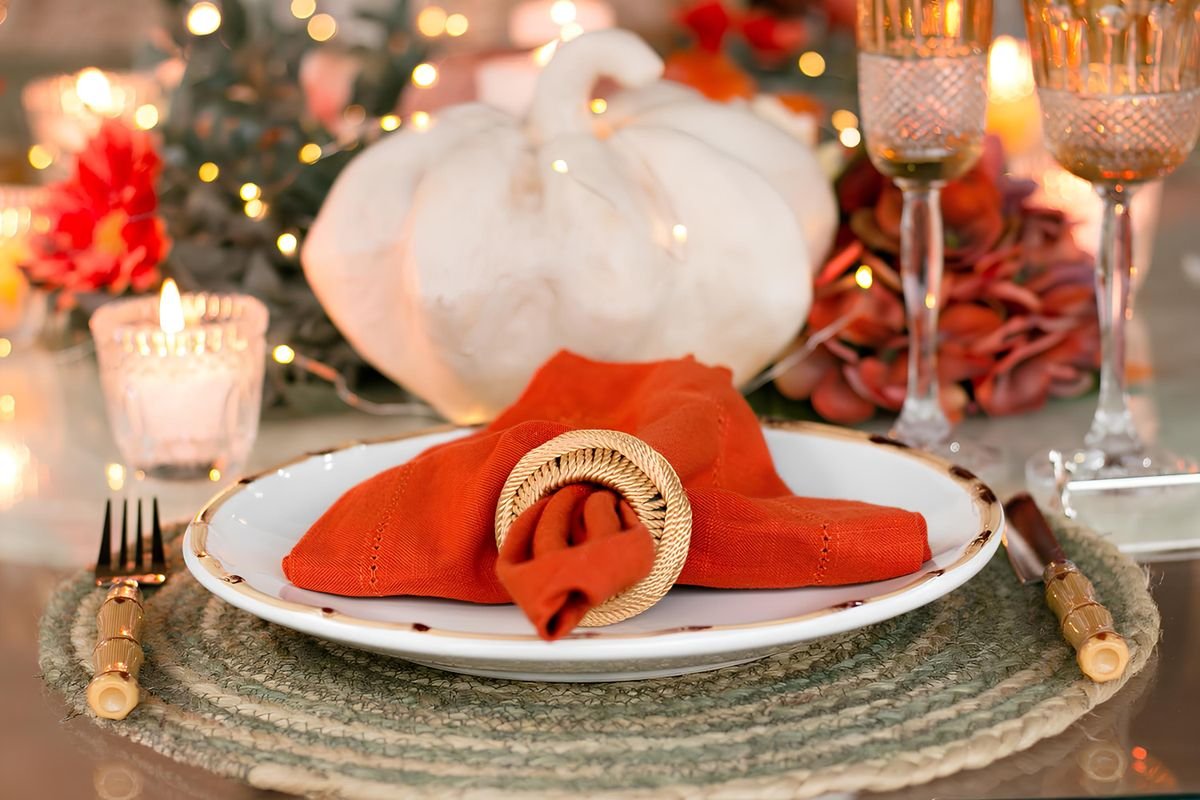 Autumn place settings with black ribbon napkin rings on dining table