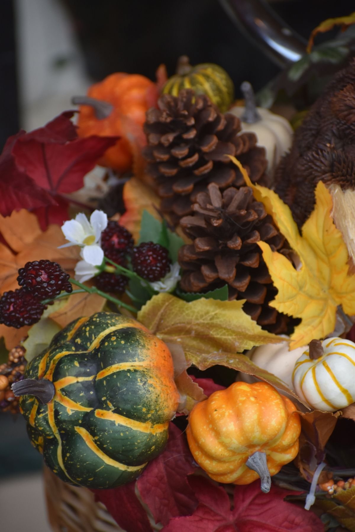 Open kitchen shelves styled with gourds pinecones and felt pumpkins autumn