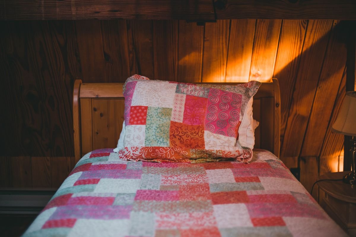 Guest bedroom with leaf print quilt and mini pumpkin tray cozy autumn