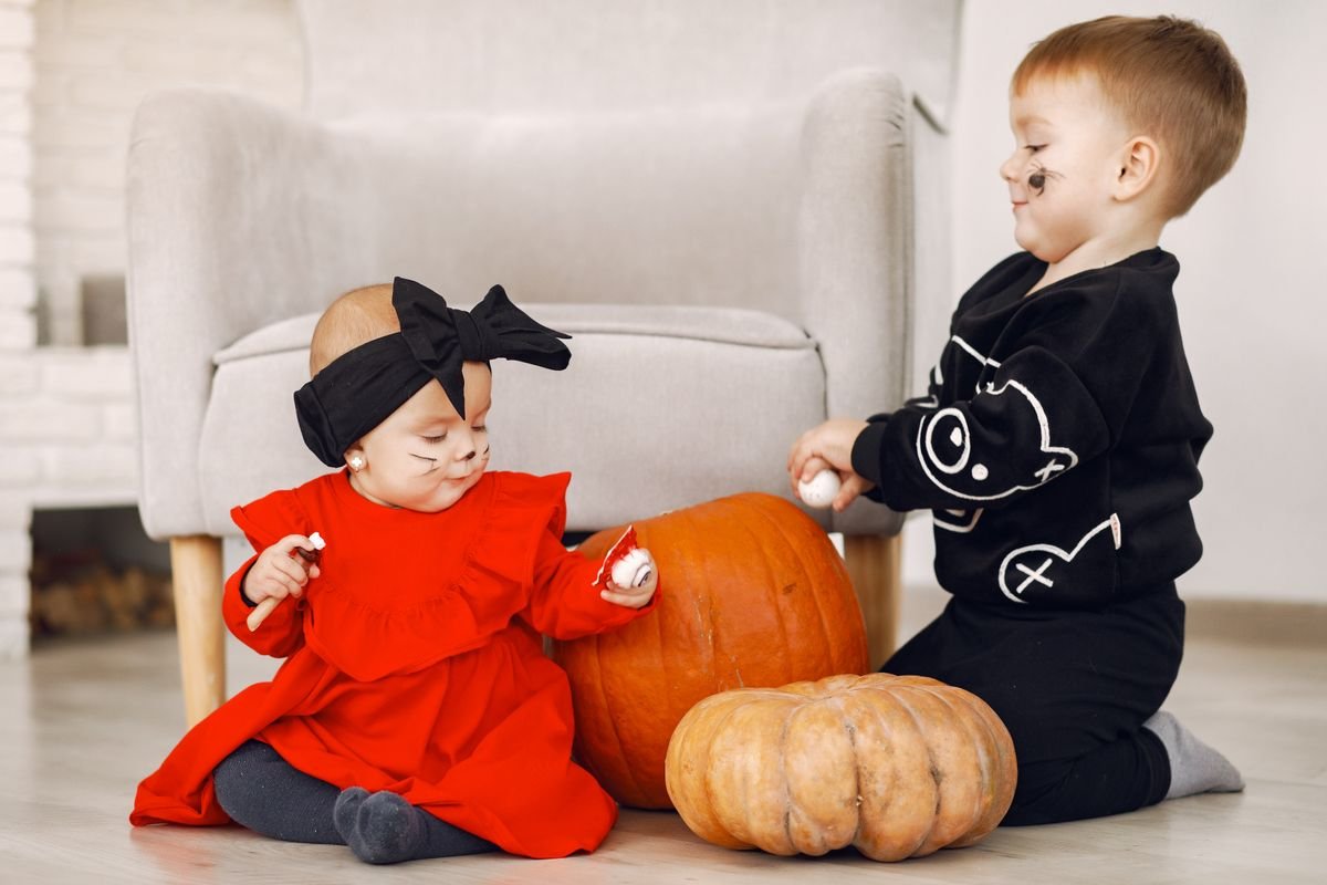 Cluster of mixed pumpkins in a living room corner with lantern