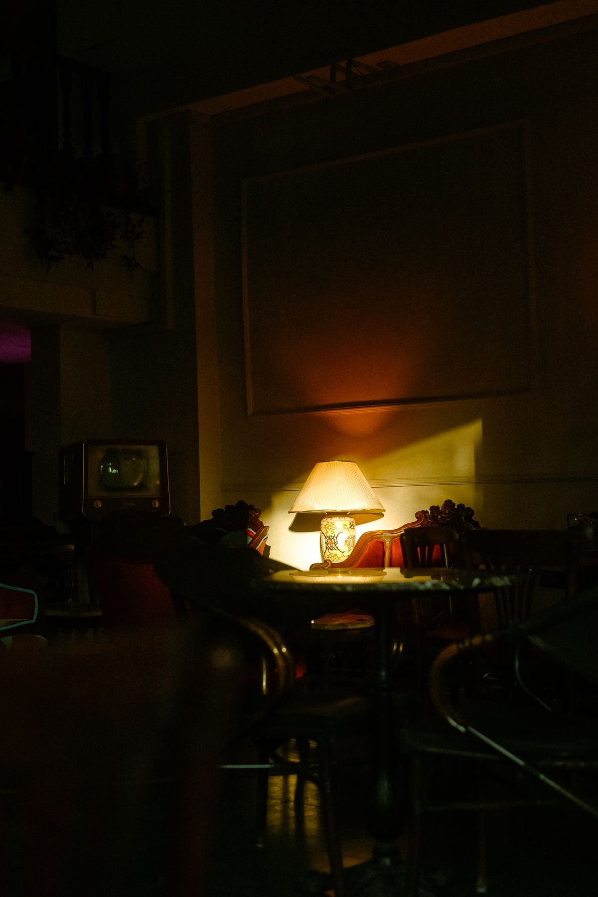 Moody amber lighting in cozy Halloween living room