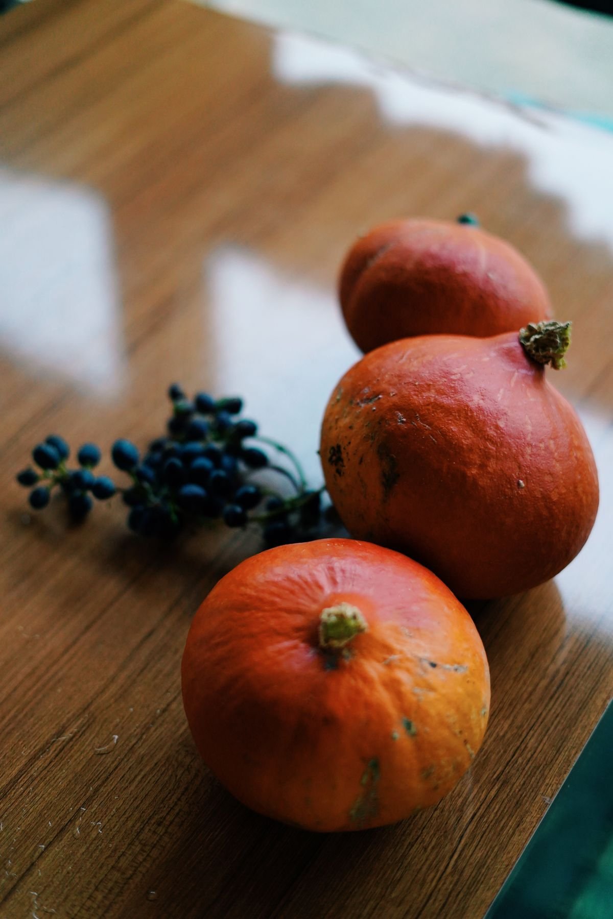 Decorative tray with pumpkins and berries styled on a living room ottoman