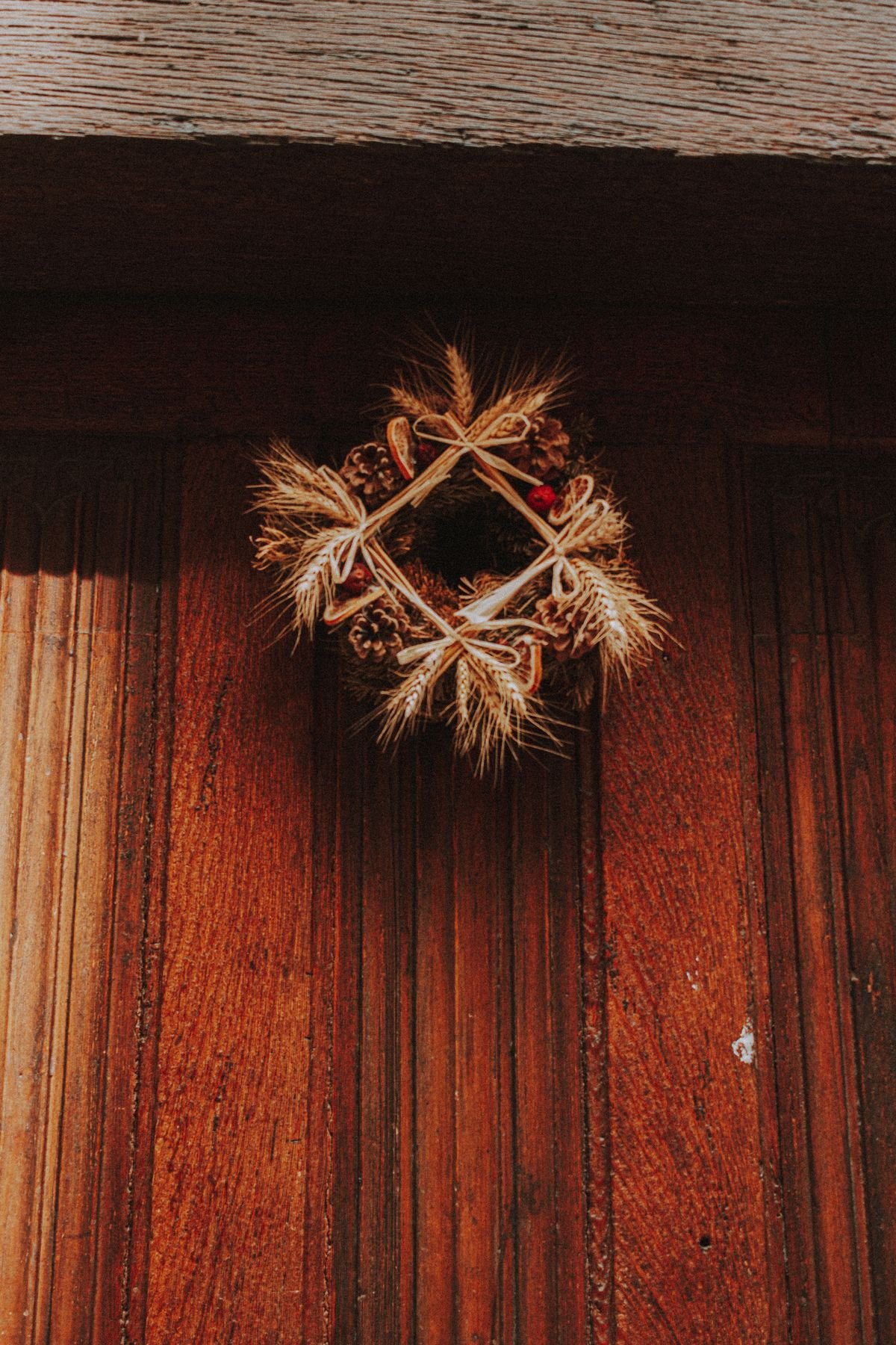 Handmade twig wreath with dried leaves and mini pumpkins
