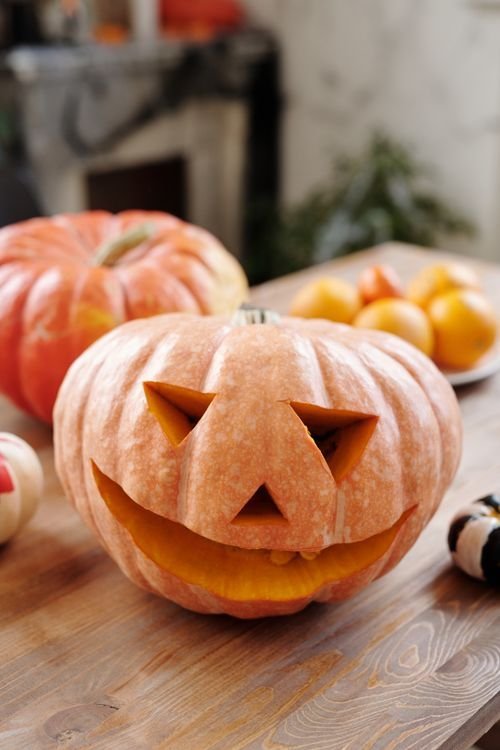 Halloween dining table centerpiece with pumpkins and candles
