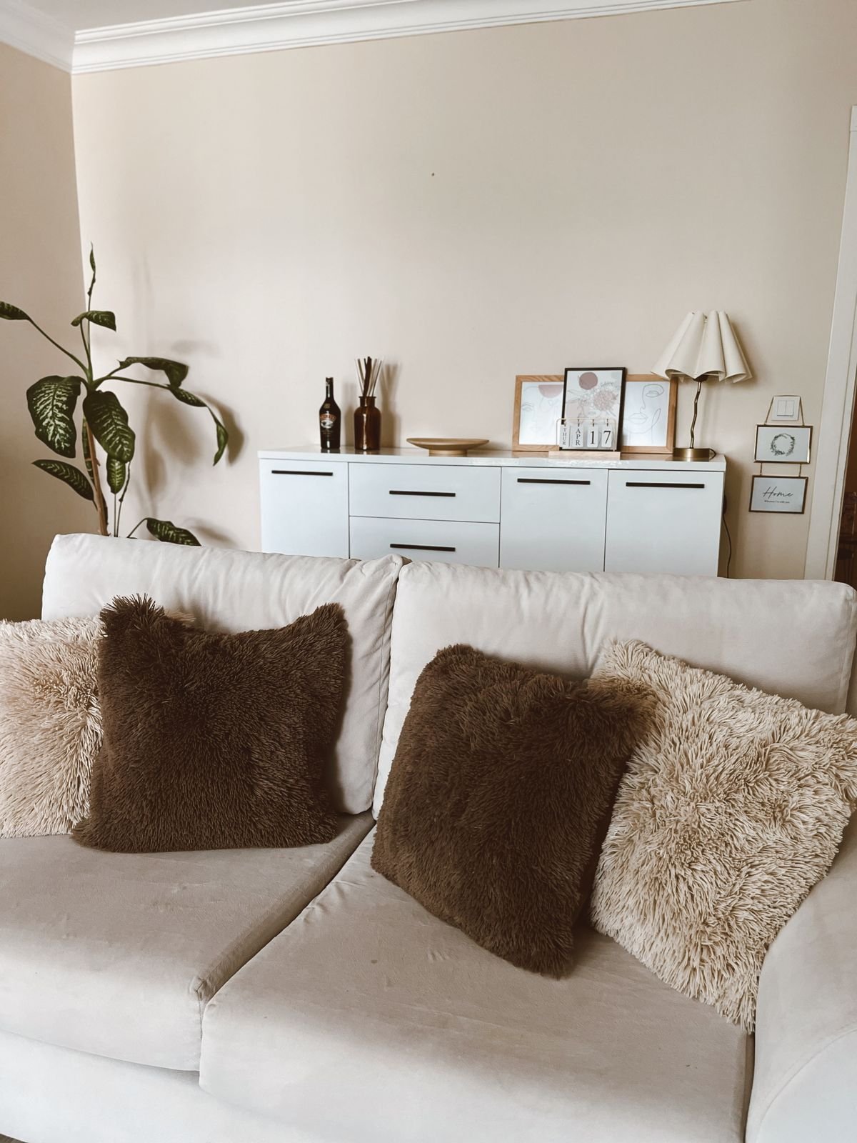 Beige sofa styled with cream and taupe Halloween cushions
