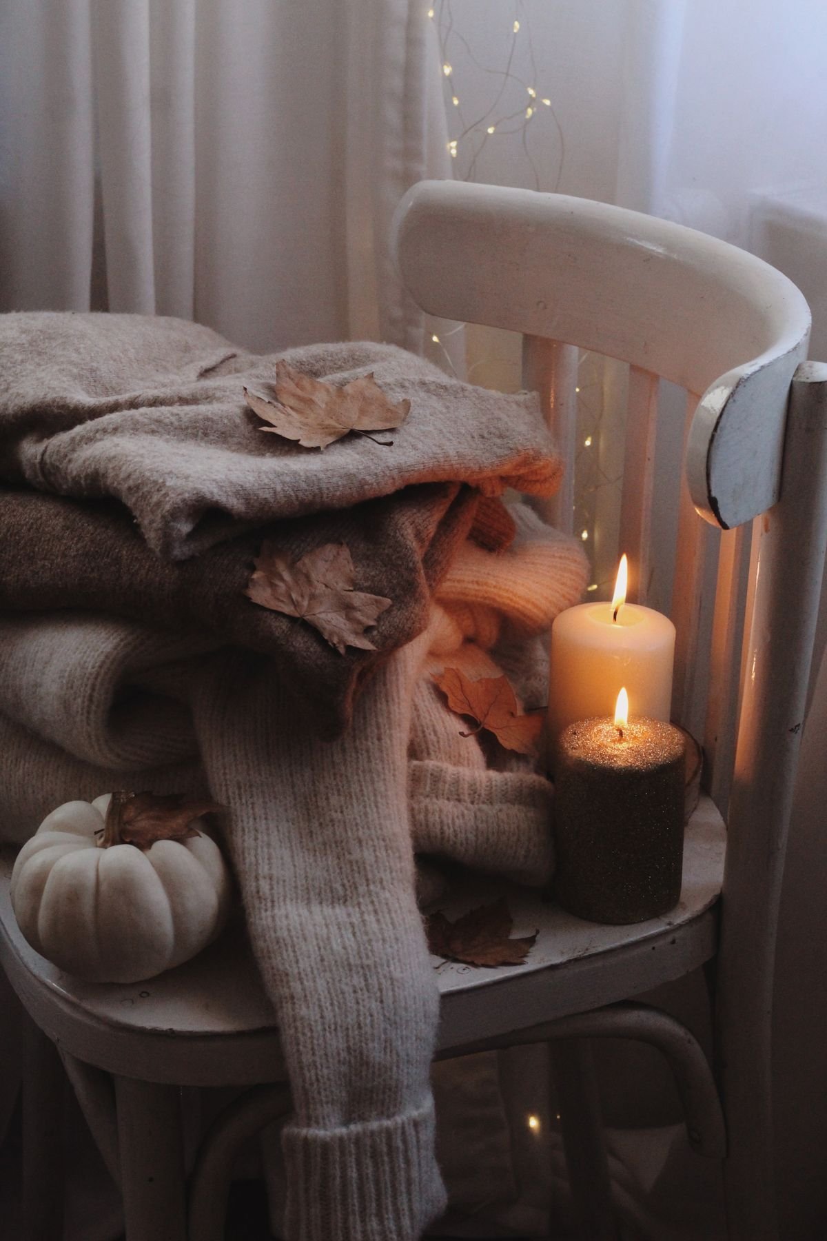 Dining chairs with beige seat cushions and pumpkin centrepiece