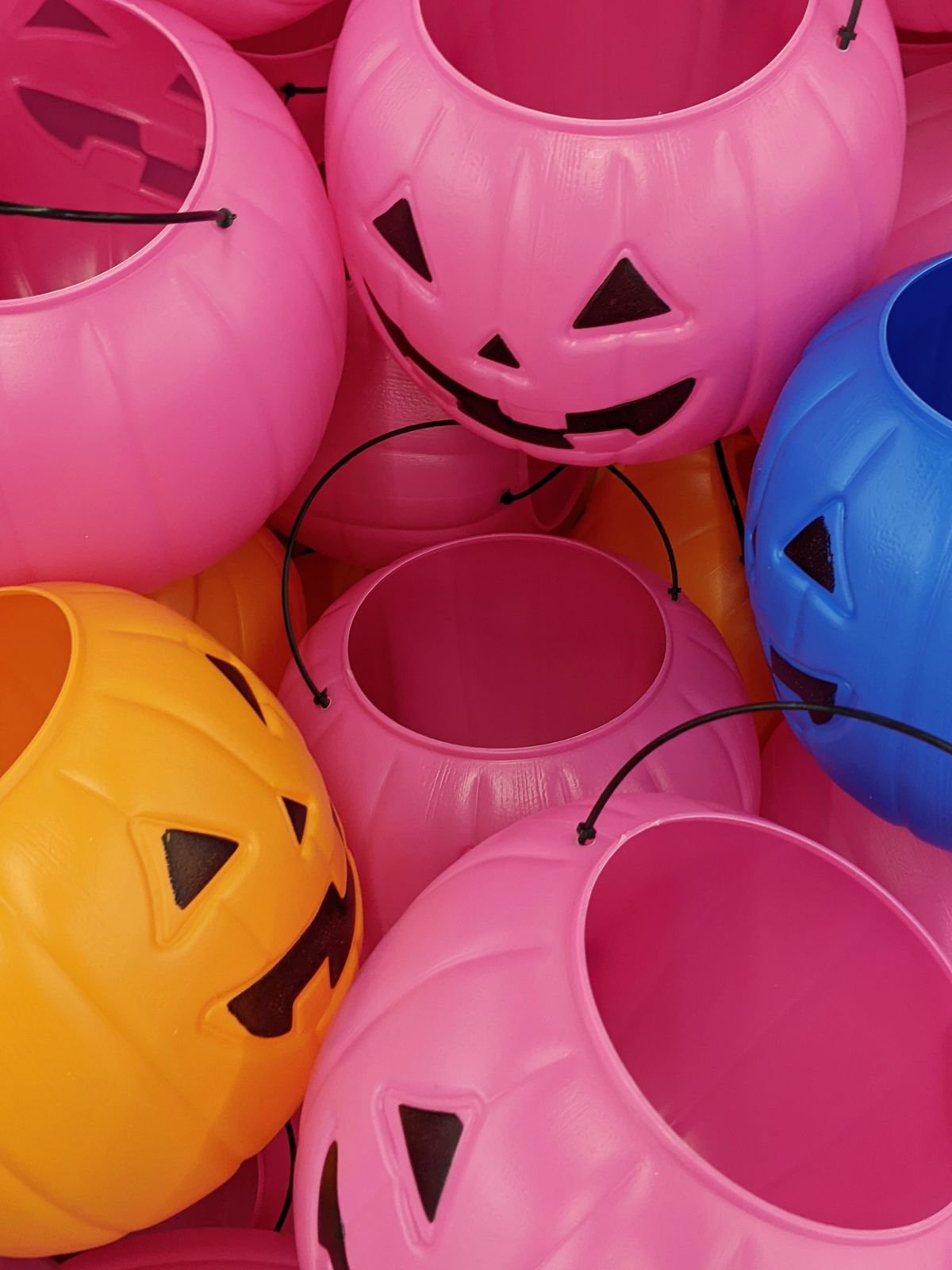 Blush pink pumpkins styled along a Halloween mantel