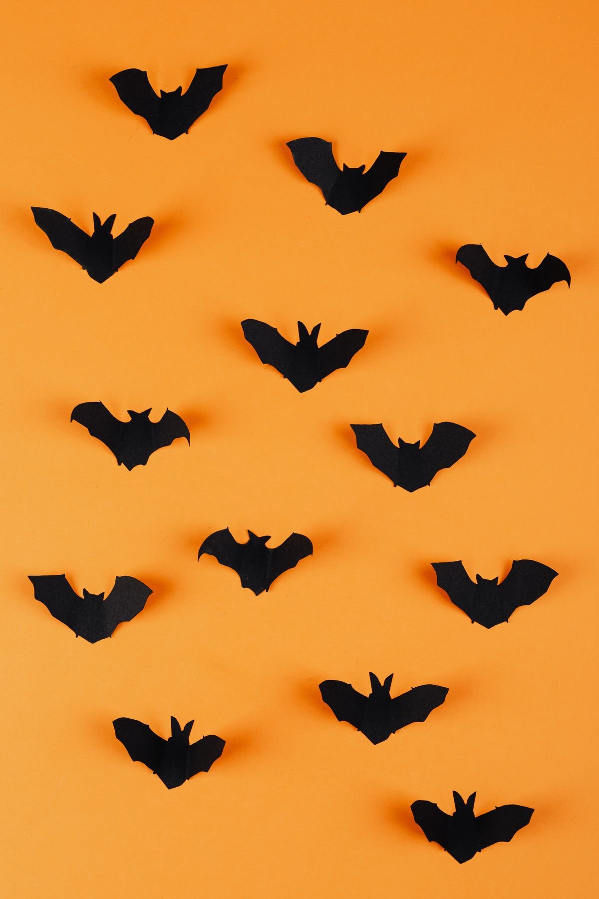 Paper bat garland hanging across a mantel