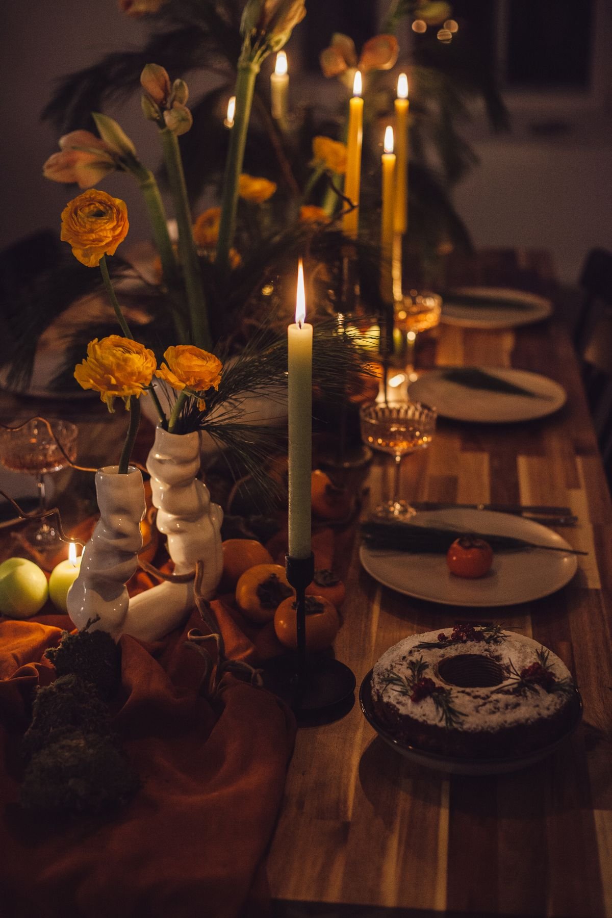 Orange taper candles on a dining table