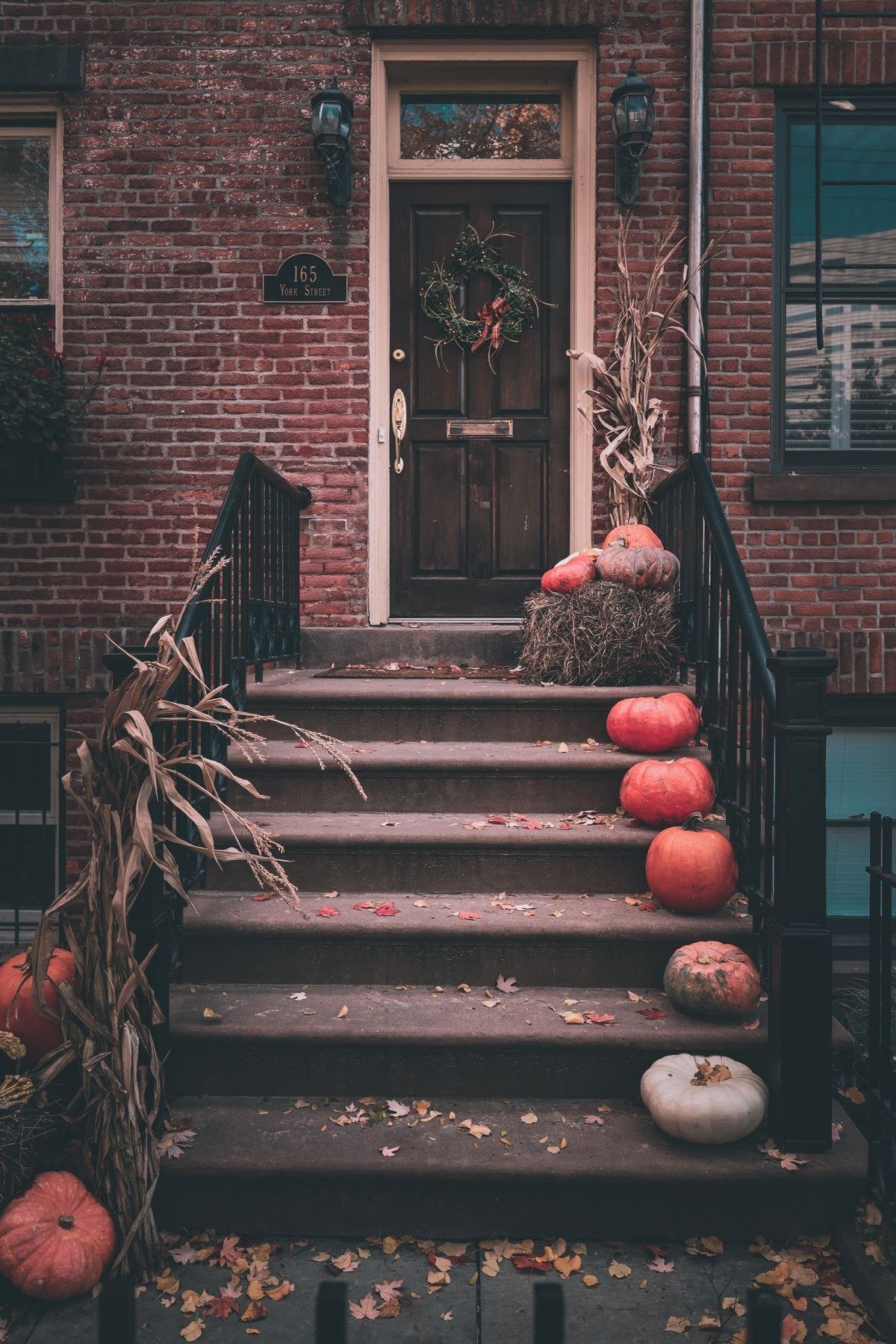 Layered porch steps with pumpkins and fall decor for Halloween