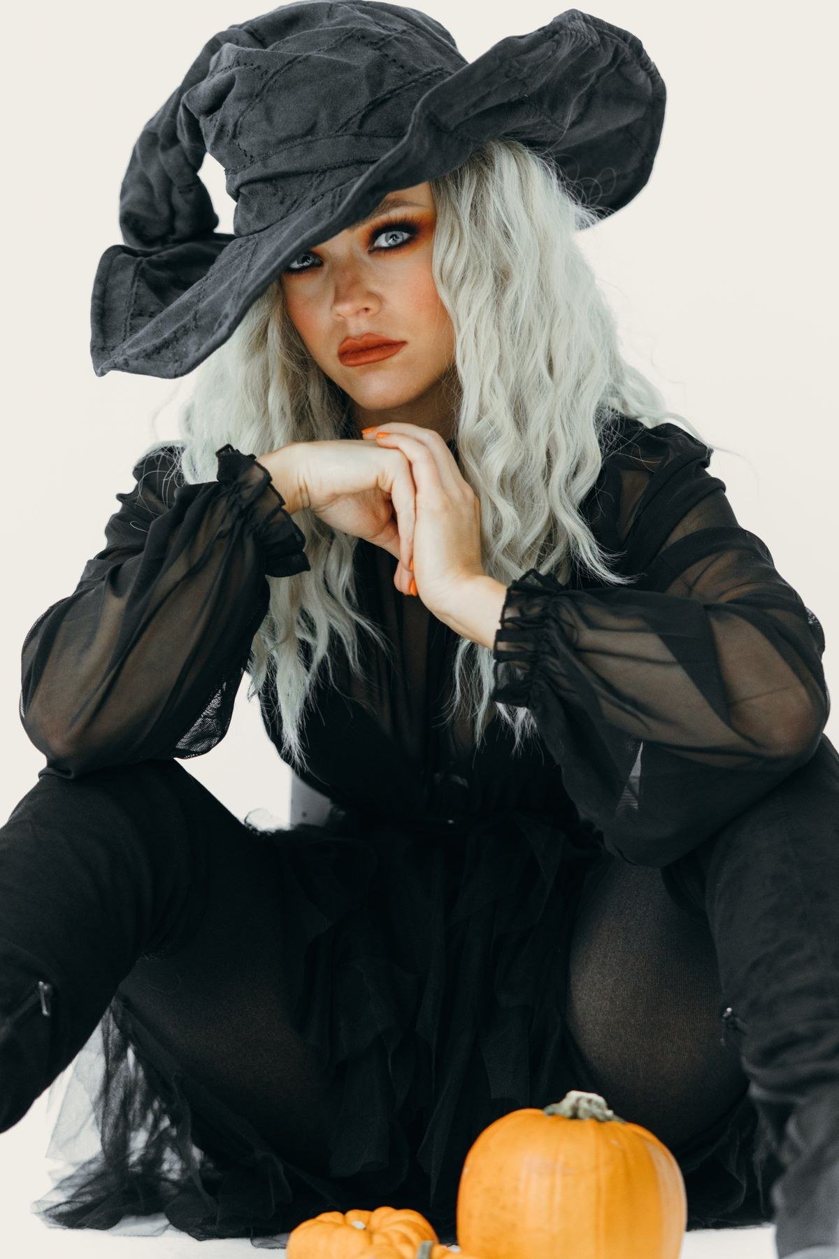 Elegant witch styling with pumpkins for a refined Halloween entrance